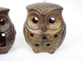 two owl figurines that are sitting next to each other