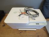 a white printer sitting on top of a wooden table
