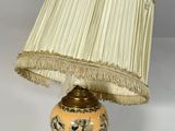 a lamp that is sitting on a table with a lamp shade on it