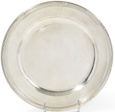 a silver plate on a stand on a white background