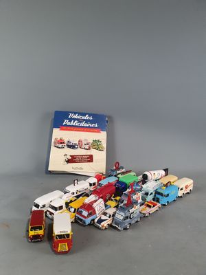 a lot of toy trucks and a book on the table