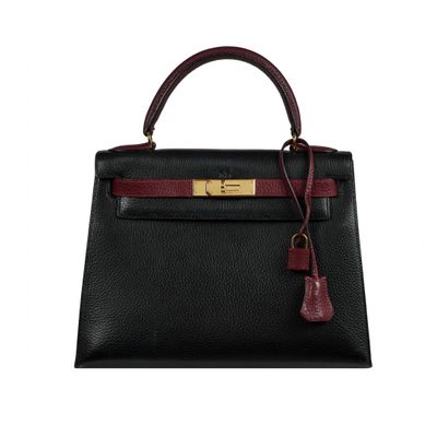 a black and burgundy leather handbag with gold hardware