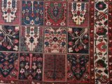 an antique persian rug with a patchwork design on a white background