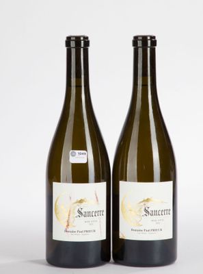 two bottles of wine sitting next to each other on a white surface