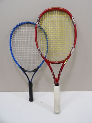 two tennis rackets sitting next to each other on a table