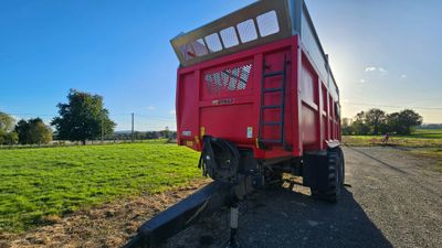 a red trailer that is parked on the side of the road