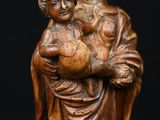 a statue of a woman holding a child in her arms
