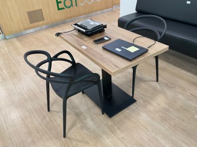 a table with a laptop on it and a chair in front of it