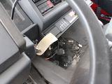 a car dashboard with a steering wheel with a paper stuck to it
