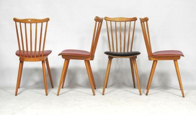 three wooden chairs sitting next to each other on a white surface