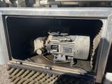 a machine that is sitting in the back of a truck