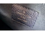 an image of a close up of a purse with a tag on it