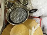 a straw hat sitting on top of a pile of items