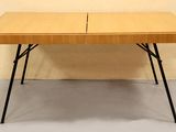 une table en bois avec deux pieds noirs et un plateau en bois