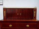 a wooden desk with a wooden top and gold trimmings