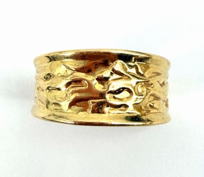 an image of a close up of a gold ring on a white surface
