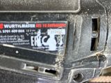 a close up of a person holding a cordless drill
