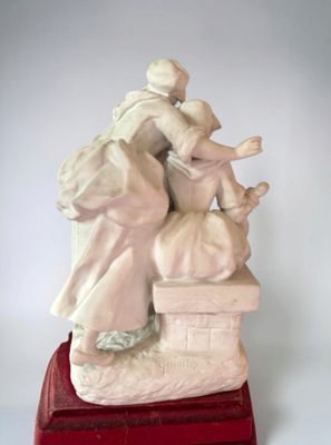 a statue of a woman sitting on top of a red box