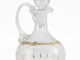 a glass decanter with a gold decoration on it