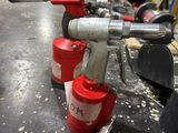a red fire hydrant sitting on a table in a workshop