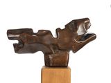 bronze sculpture of a dog on a wooden base on a white background