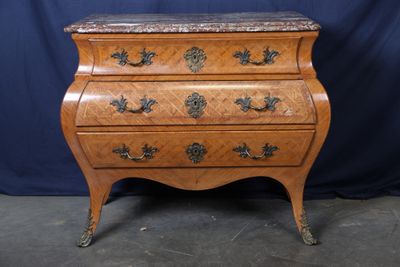 an image of a wooden chest of drawers with marble top