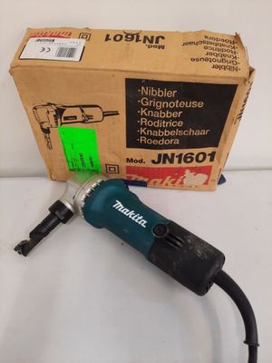 a close up of a corded drill with a box in the background