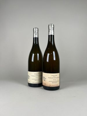 two bottles of wine sitting next to each other on a table