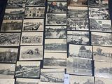 many old postcards of different types and sizes are on a table