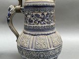 an image of a blue and white vase with a dragon handle