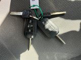 two keys that are sitting on the seat of a car