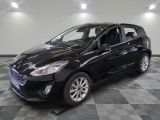 a black ford fiesta parked on a checkered floor in a garage