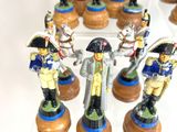 many figurines of soldiers on display on a clear shelf