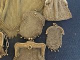 gold mesh purses and other items on a blue surface