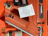 an orange tool box with a stapler, glue gun, and other tools
