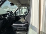 a white truck with the door open and the driver ' s seat down
