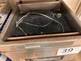 a metal sink with a black tank inside of it