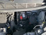 a car that has a car battery in it ' s trunk