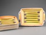 four square dishes with yellow and green designs on them