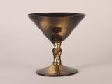 an image of a black and gold goblet sitting on top of a table