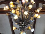 a chandelier with flowers hanging from it ' s ceiling