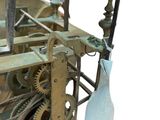 a clock that is being worked on by a man