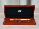 a wooden box with a pen in it sitting on a table
