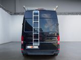 a black van with a ladder on the back of it