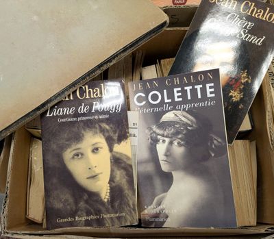 books in a cardboard box are stacked on top of each other