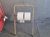 two rolls of toilet paper sitting on a metal rack