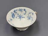 blue and white porcelain bowl with floral design on the rim