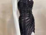 the mannequin is wearing a black dress on a white mannequin