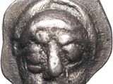 a close up of a silver coin with a face on it