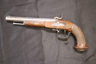 un pistolet exposé sur un tissu noir